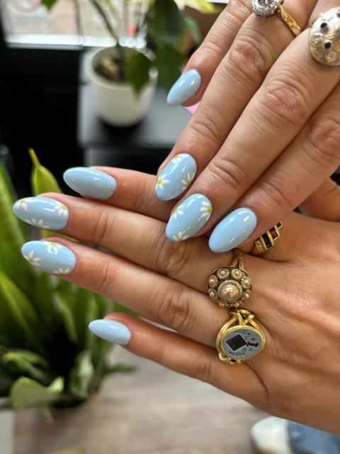 Soft blue nails with hand-painted details