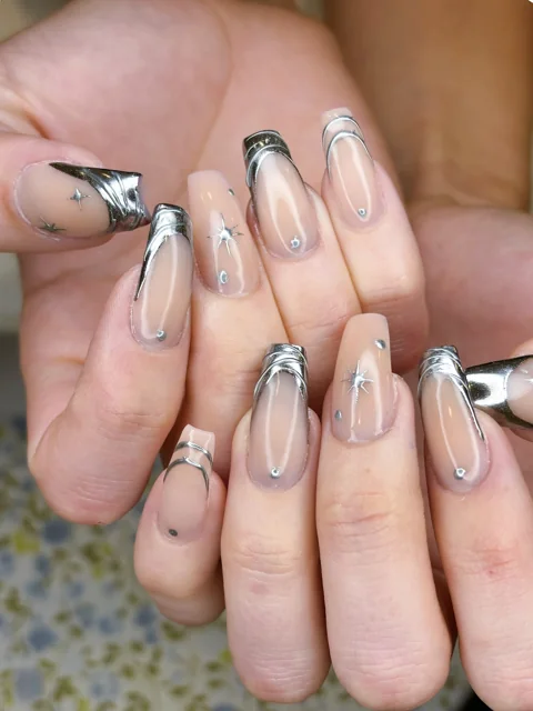 Silver-tipped nail art with delicate metallic details
